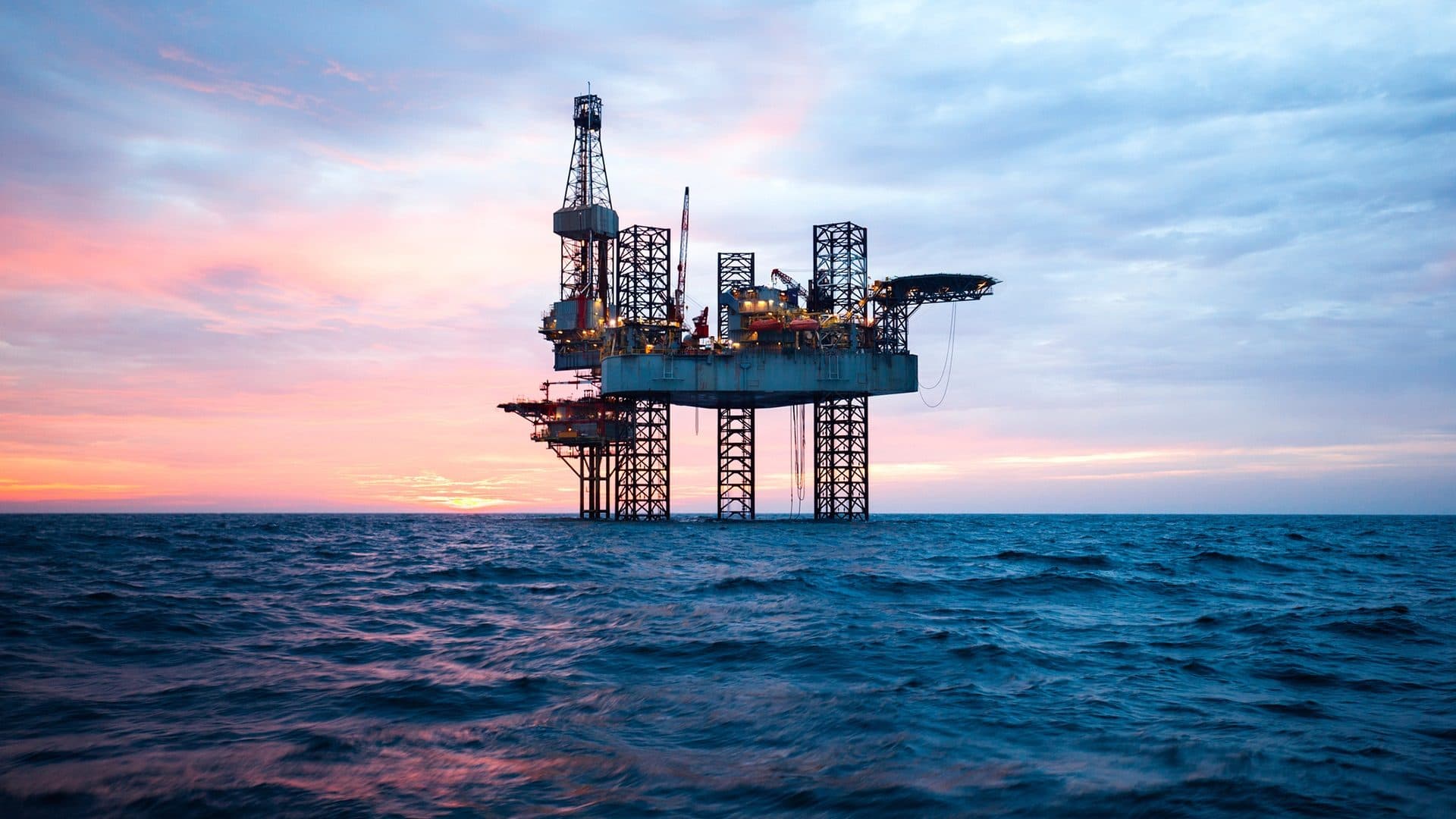 Offshore energy platform at sunset, representing the petrochemical and energy sectors Microplasma serves